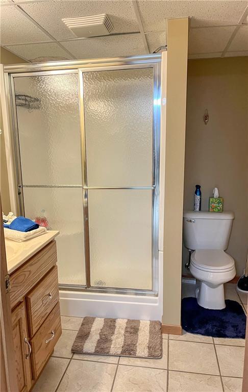 608 3rd St, Cameron, WI 54822 - full bath featuring a drop ceiling, tile patterned floors, vanity, and a stall shower