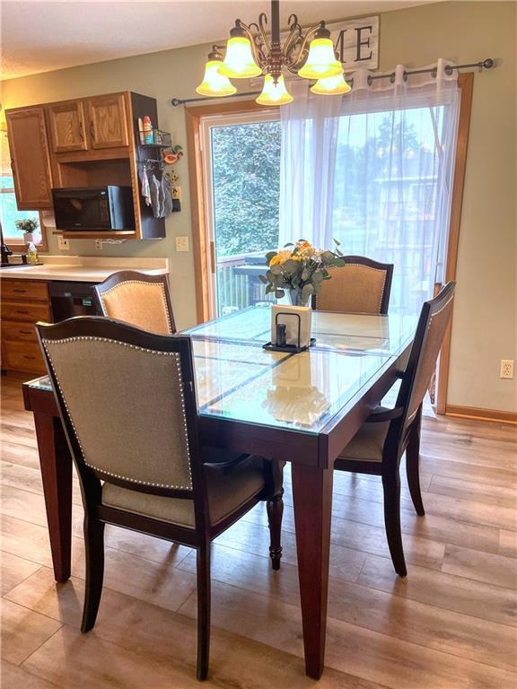 608 3rd St, Cameron, WI 54822 - dining area featuring a chandelier and light wood finished floors