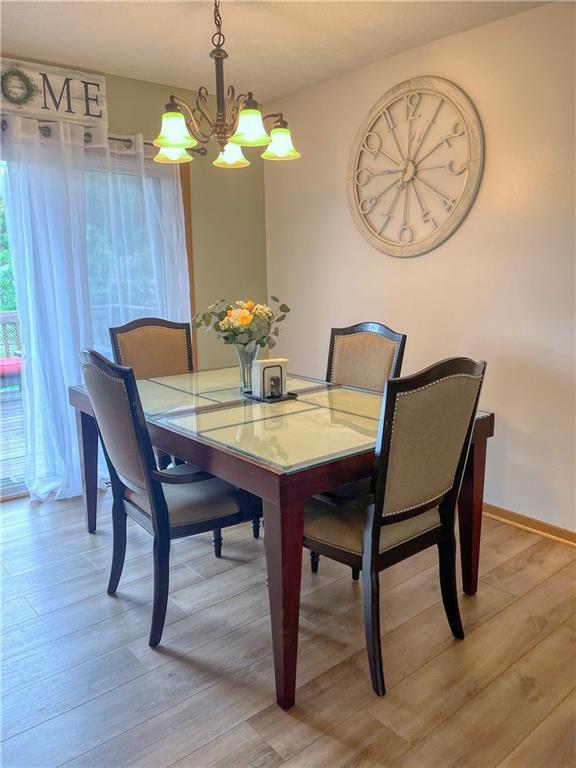 608 3rd St, Cameron, WI 54822 - dining area featuring a chandelier and light wood-style floors