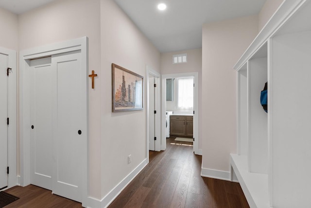 N55W19373 Red Crown Ln, Menomonee Falls, WI 53051 - hall featuring washer / clothes dryer, dark wood finished floors, and recessed lighting