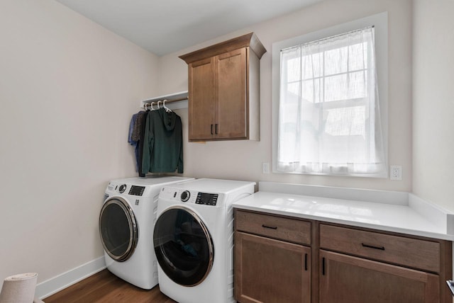 N55W19373 Red Crown Ln, Menomonee Falls, WI 53051 - laundry area featuring cabinet space, washing machine and dryer, healthy amount of natural light, and dark wood-style flooring