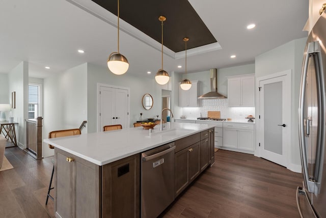 N55W19373 Red Crown Ln, Menomonee Falls, WI 53051 - kitchen featuring stainless steel appliances, wall chimney range hood, backsplash, dark wood finished floors, and recessed lighting