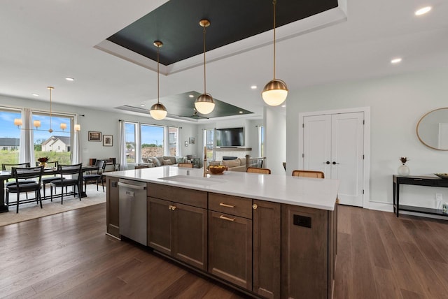 N55W19373 Red Crown Ln, Menomonee Falls, WI 53051 - kitchen with stainless steel dishwasher, a tray ceiling, light countertops, dark wood-style floors, and recessed lighting