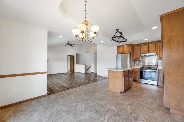 4815 Isabella Cir, Oneida, WI 54155 - kitchen with stainless steel appliances, brown cabinetry, a chandelier, a tray ceiling, and recessed lighting