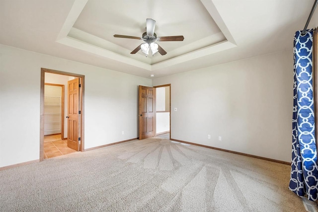 4815 Isabella Cir, Oneida, WI 54155 - unfurnished bedroom with light colored carpet, a tray ceiling, a ceiling fan, and ensuite bath