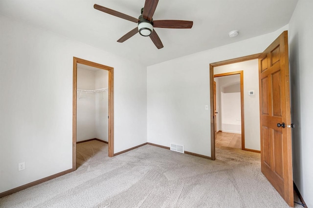 4815 Isabella Cir, Oneida, WI 54155 - unfurnished bedroom featuring light colored carpet, a spacious closet, a closet, and ceiling fan