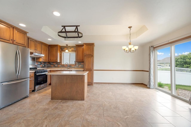 4815 Isabella Cir, Oneida, WI 54155 - kitchen with appliances with stainless steel finishes, under cabinet range hood, a chandelier, healthy amount of natural light, and recessed lighting