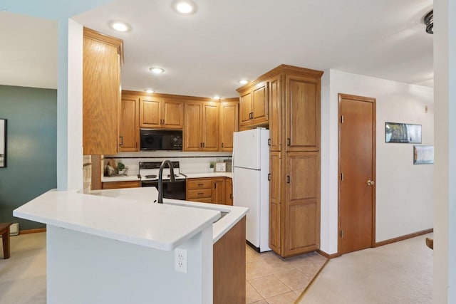 735 Cherokee Path, Lake Mills, WI 53551 - kitchen with white appliances, light countertops, recessed lighting, brown cabinetry, and a peninsula