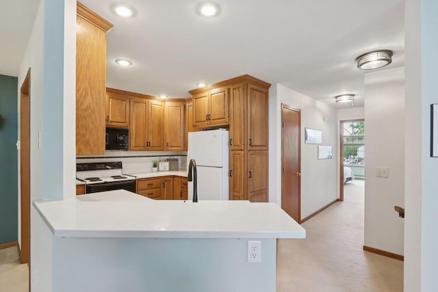 735 Cherokee Path, Lake Mills, WI 53551 - kitchen with electric range oven, freestanding refrigerator, black microwave, light countertops, and recessed lighting