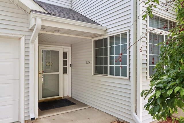 735 Cherokee Path, Lake Mills, WI 53551 - doorway to property featuring roof with shingles