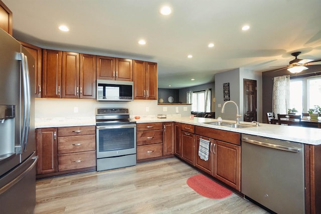 215 Marcoe St, Fond Du Lac, WI 54937 - kitchen featuring appliances with stainless steel finishes, a peninsula, recessed lighting, light countertops, and brown cabinets