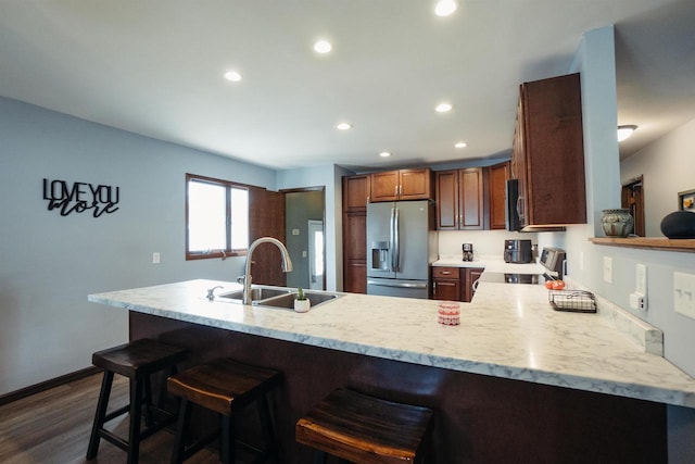 215 Marcoe St, Fond Du Lac, WI 54937 - kitchen featuring stainless steel refrigerator with ice dispenser, range, a peninsula, dark wood-style floors, and recessed lighting