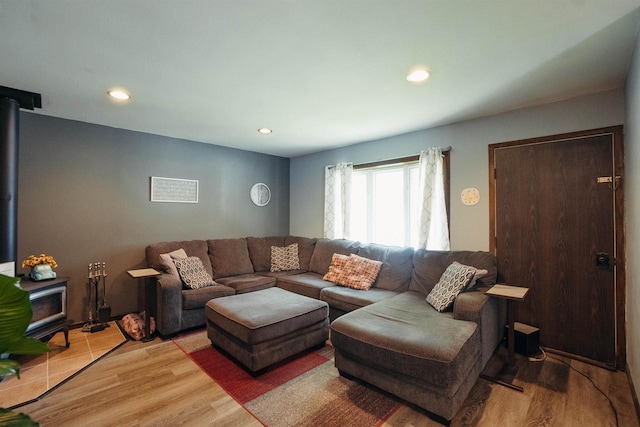 215 Marcoe St, Fond Du Lac, WI 54937 - living room featuring a wood stove, light wood-style flooring, and recessed lighting