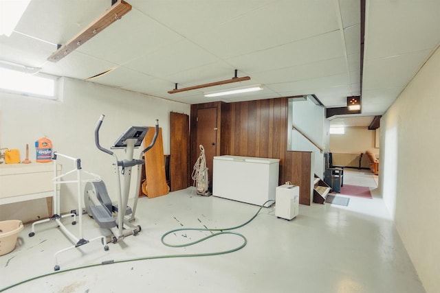 215 Marcoe St, Fond Du Lac, WI 54937 - basement with refrigerator, a drop ceiling, and wood walls