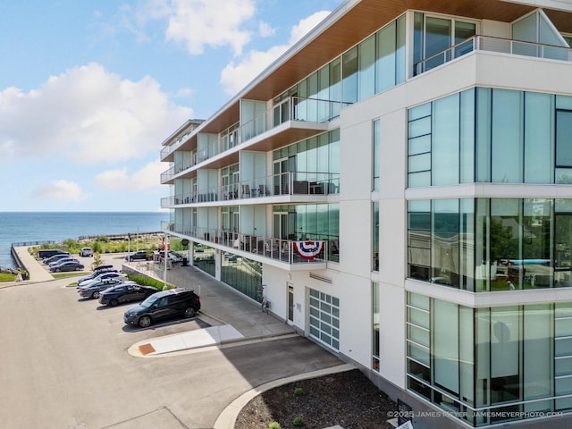 324 N Lake St Unit 204, Port Washington, WI 53074 - view of apartment building / complex featuring a water view and uncovered parking