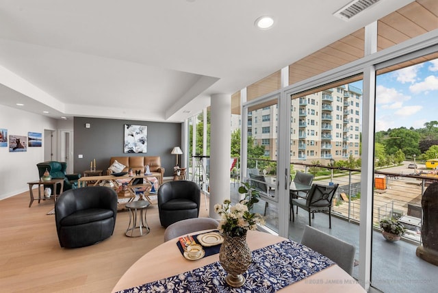 324 N Lake St Unit 204, Port Washington, WI 53074 - living room with a wall of windows, wood finished floors, a tray ceiling, and recessed lighting