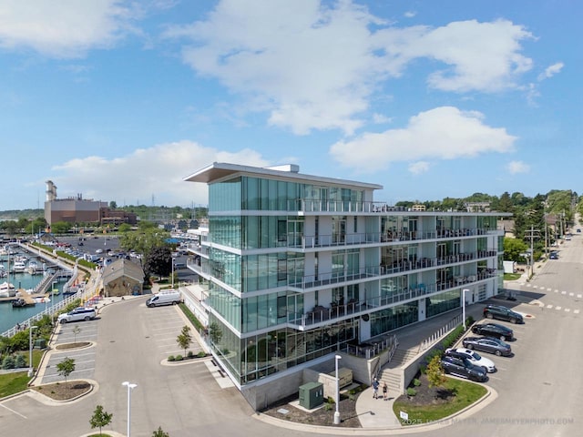 324 N Lake St Unit 204, Port Washington, WI 53074 - view of property with uncovered parking, a water view, and view of marina