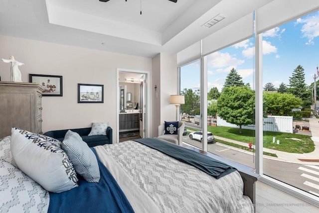 324 N Lake St Unit 204, Port Washington, WI 53074 - bedroom with access to outside, ensuite bath, and a tray ceiling