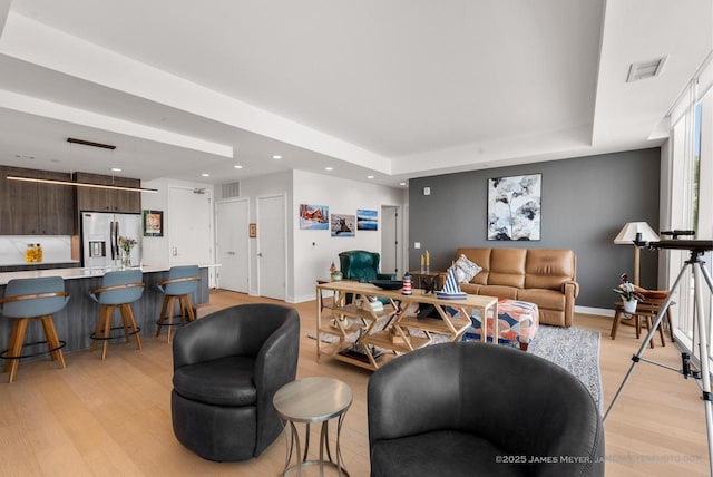 324 N Lake St Unit 204, Port Washington, WI 53074 - living area with light wood-style floors, recessed lighting, and a tray ceiling