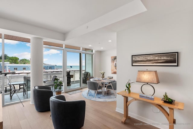 324 N Lake St Unit 204, Port Washington, WI 53074 - living area with light wood finished floors, recessed lighting, a wall of windows, and a water view