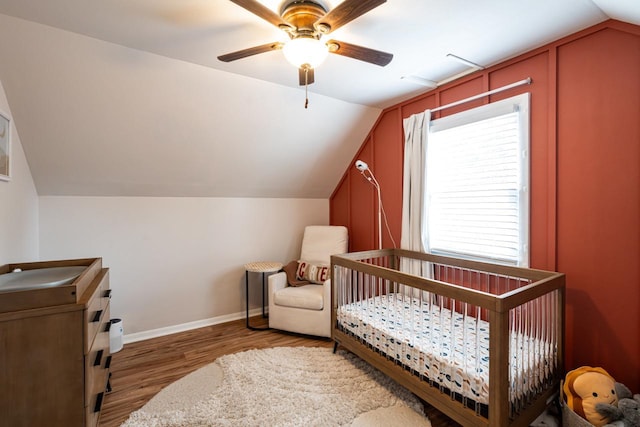 10610 W Rogers St, West Allis, WI 53227 - bedroom with wood finished floors, vaulted ceiling, ceiling fan, and a nursery area