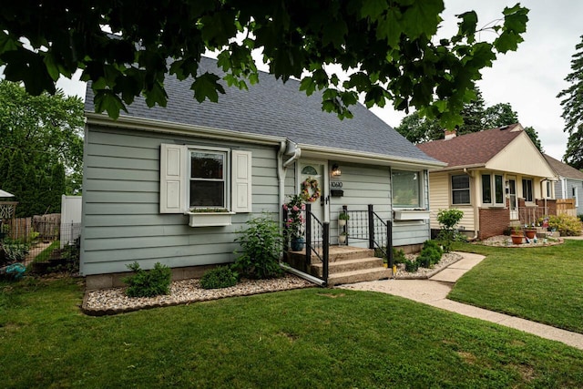 10610 W Rogers St, West Allis, WI 53227 - view of front of home featuring a front yard and roof with shingles