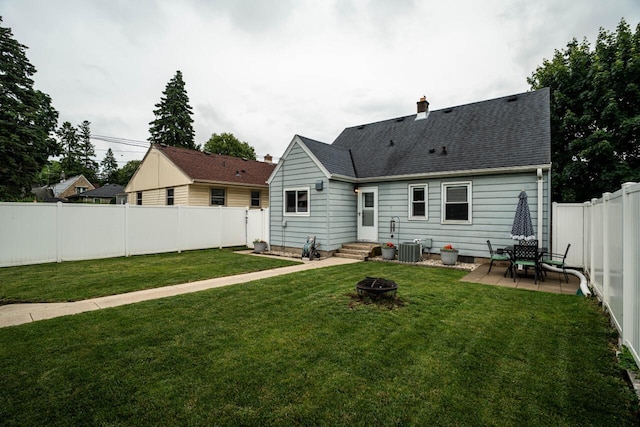 10610 W Rogers St, West Allis, WI 53227 - rear view of house with a fenced backyard, a patio area, roof with shingles, an outdoor fire pit, and a chimney