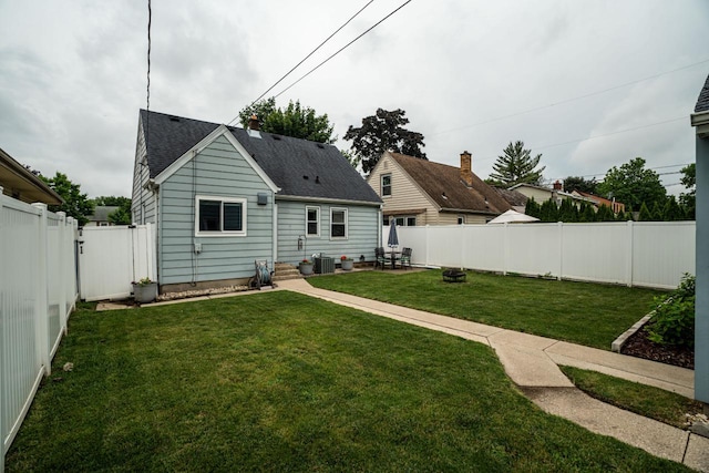 10610 W Rogers St, West Allis, WI 53227 - back of property with a fenced backyard, roof with shingles, and a patio area