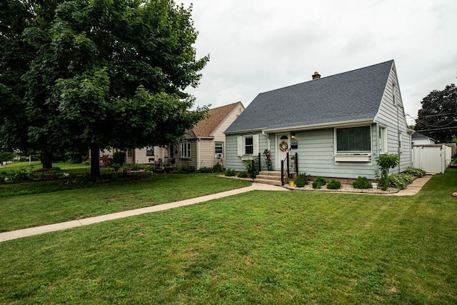 10610 W Rogers St, West Allis, WI 53227 - cape cod house with roof with shingles, a front lawn, and a chimney