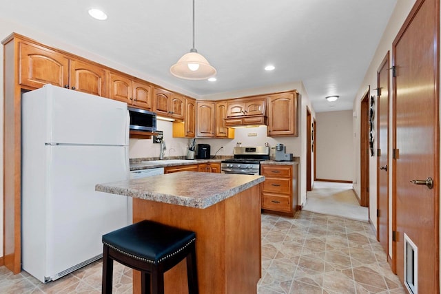 1899 Riverside Dr Unit A, Suamico, WI 54313 - kitchen featuring stainless steel appliances, a center island, pendant lighting, brown cabinetry, and recessed lighting