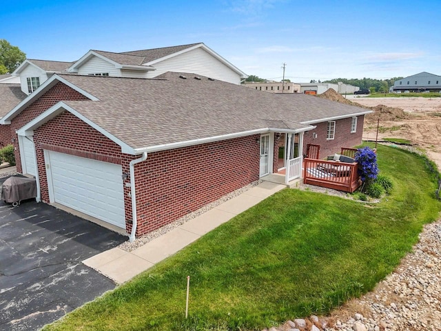 1899 Riverside Dr Unit A, Suamico, WI 54313 - view of front of property with brick siding, a shingled roof, an attached garage, a front yard, and driveway