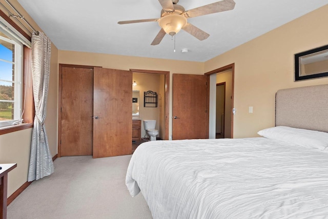 1899 Riverside Dr Unit A, Suamico, WI 54313 - bedroom with light carpet, a ceiling fan, and ensuite bathroom
