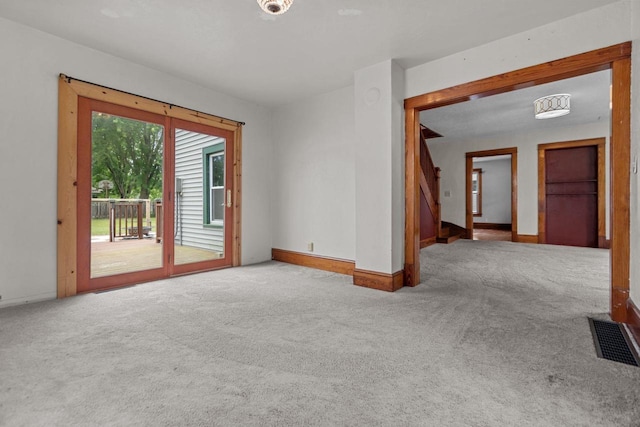 102 10th St, Clintonville, WI 54929 - carpeted empty room with baseboards and stairway