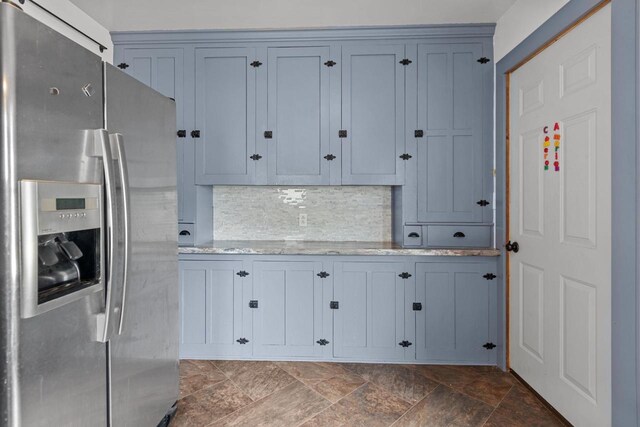 102 10th St, Clintonville, WI 54929 - kitchen featuring stainless steel fridge, backsplash, dark stone finish floors, and light stone counters