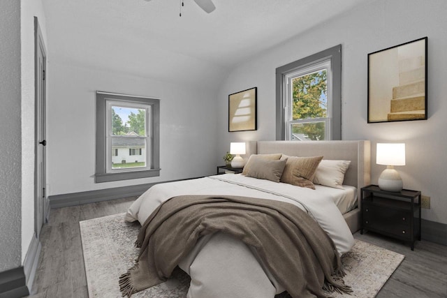 102 10th St, Clintonville, WI 54929 - bedroom with wood finished floors, vaulted ceiling, and a ceiling fan