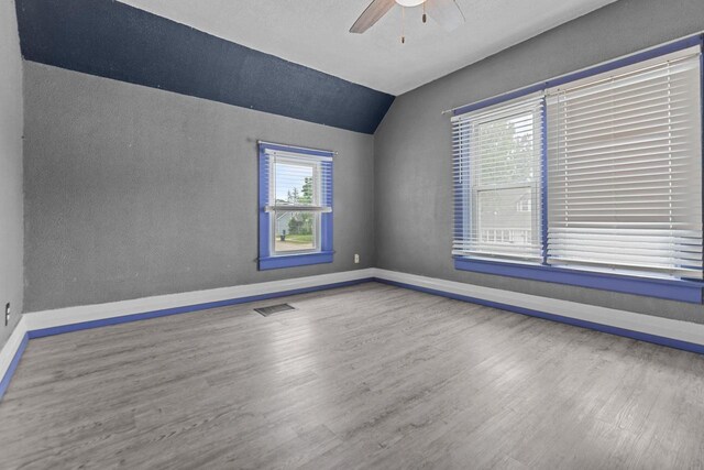 102 10th St, Clintonville, WI 54929 - empty room featuring a ceiling fan, lofted ceiling, wood finished floors, and a textured wall