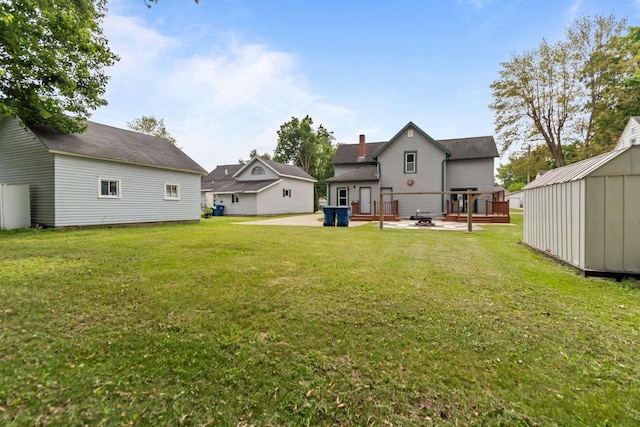 102 10th St, Clintonville, WI 54929 - view of grassy yard featuring a patio and a storage shed