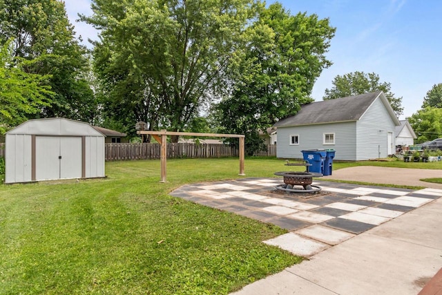 102 10th St, Clintonville, WI 54929 - view of yard featuring a fire pit, a shed, and a patio area