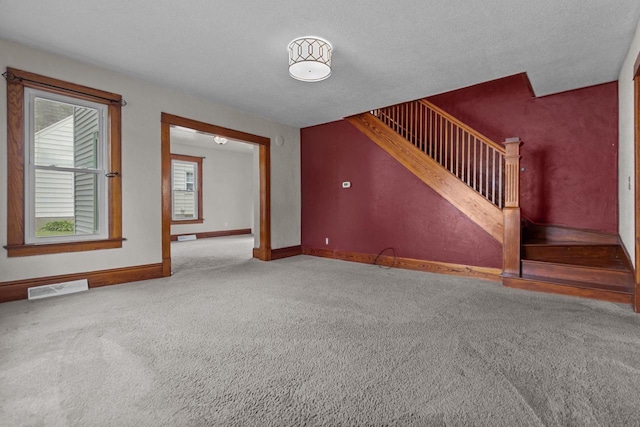 102 10th St, Clintonville, WI 54929 - unfurnished living room featuring carpet floors and stairs