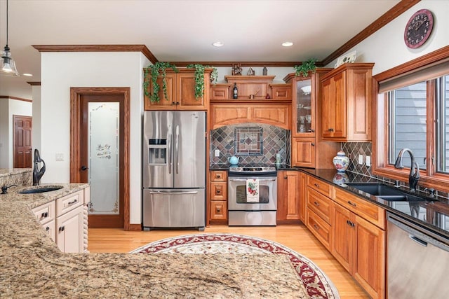 S3358 Hass Ln, Viroqua, WI 54618 - kitchen with stainless steel appliances, crown molding, light wood-type flooring, light stone counters, and tasteful backsplash