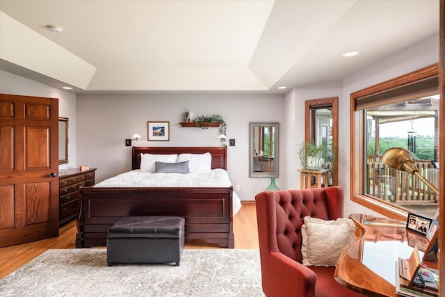 S3358 Hass Ln, Viroqua, WI 54618 - bedroom with light wood finished floors, recessed lighting, a tray ceiling, and access to exterior