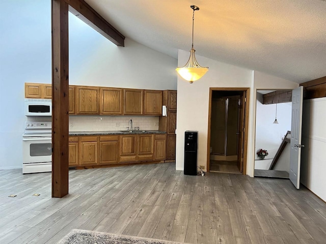 2400 Church St, Stevens Point, WI 54481 - kitchen featuring white appliances, brown cabinets, light wood-style floors, and decorative backsplash