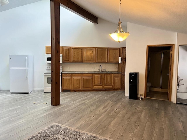 2400 Church St, Stevens Point, WI 54481 - kitchen featuring white appliances, brown cabinetry, high vaulted ceiling, light wood-type flooring, and backsplash