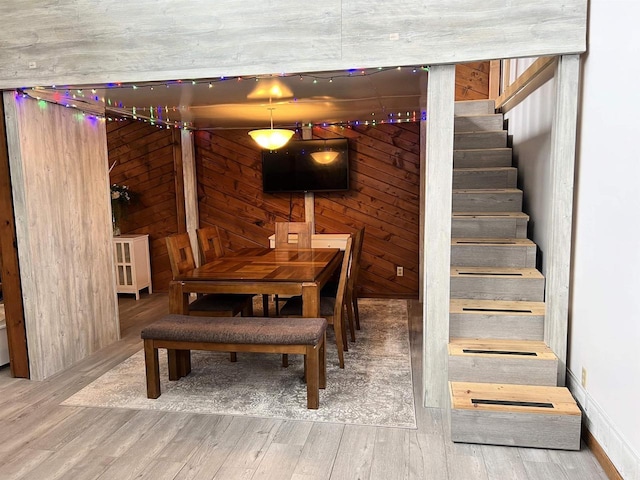 2400 Church St, Stevens Point, WI 54481 - dining room featuring wood finished floors, stairs, and wooden walls