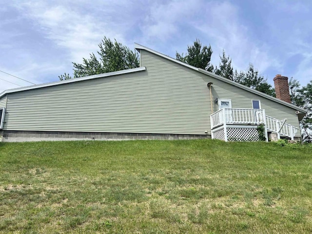 2400 Church St, Stevens Point, WI 54481 - view of side of property with a yard, a chimney, and a wooden deck
