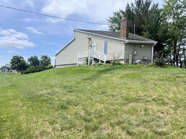2400 Church St, Stevens Point, WI 54481 - rear view of house featuring a chimney and a yard