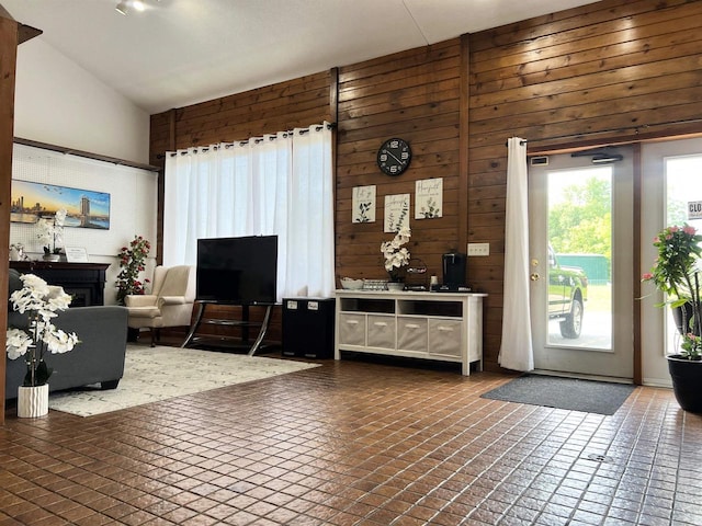 2400 Church St, Stevens Point, WI 54481 - living area with lofted ceiling, wood walls, and brick patterned floors
