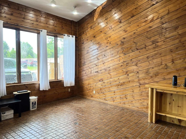 2400 Church St, Stevens Point, WI 54481 - spare room with wood walls and brick patterned floors
