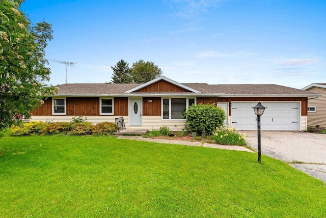 1517 Navarino St, Algoma, WI 54201 - single story home with asphalt driveway, a front lawn, a garage, and board and batten siding