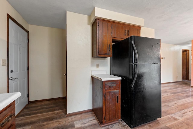 1517 Navarino St, Algoma, WI 54201 - kitchen with freestanding refrigerator, light wood-style flooring, and light countertops